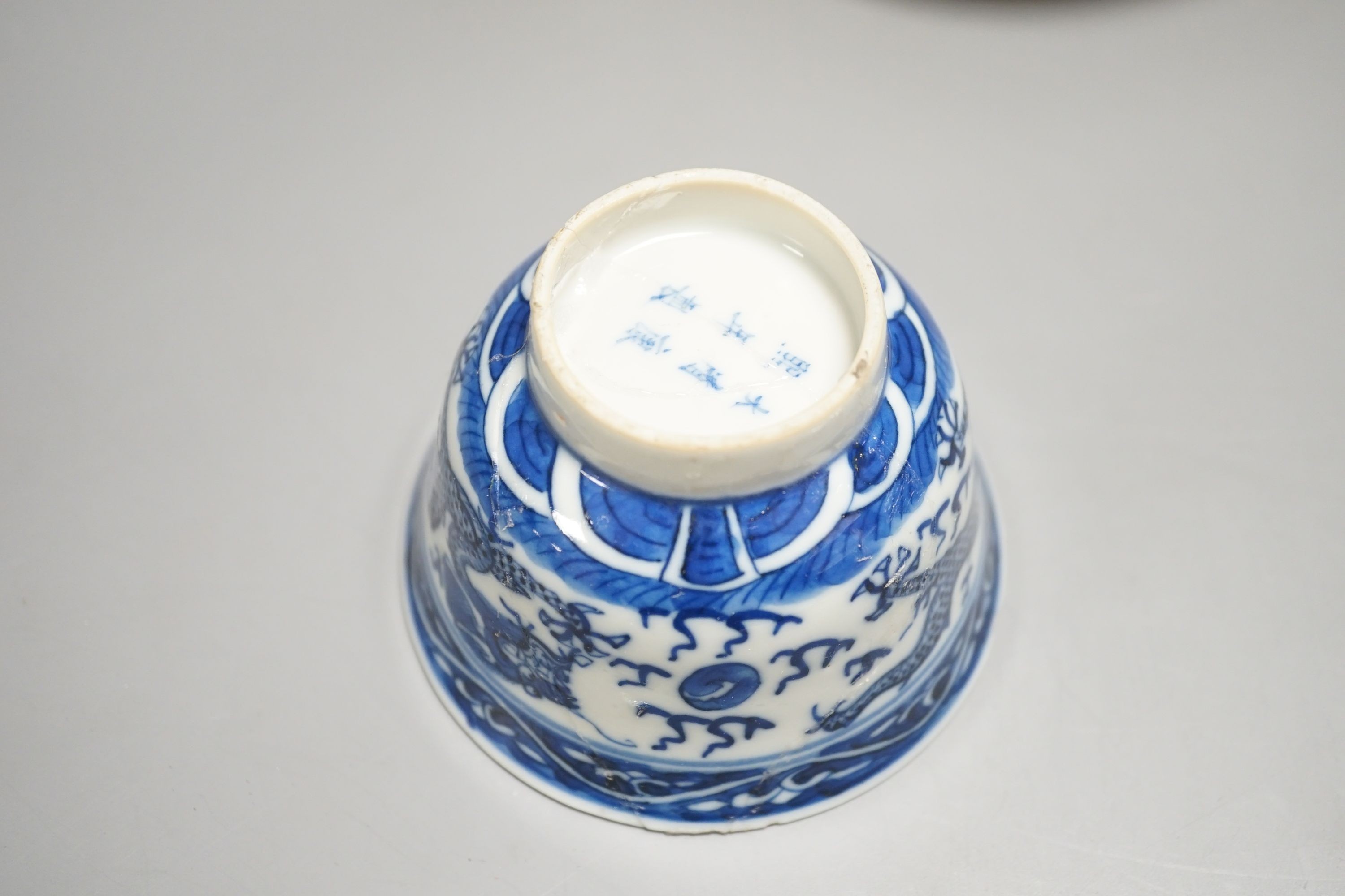 A 19th century Chinese famille rose bowl and saucer, a blue and white tea bowl on stand, a hardstone carving and three 18th century blue and white plates